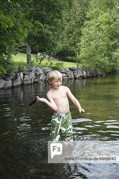 Boy Standing in Shallow Water