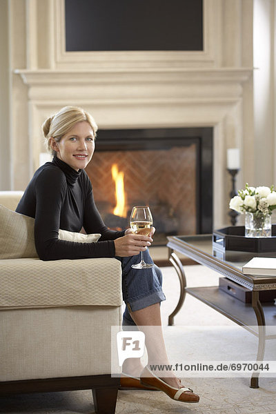 Woman with Glass of Wine in Living Room