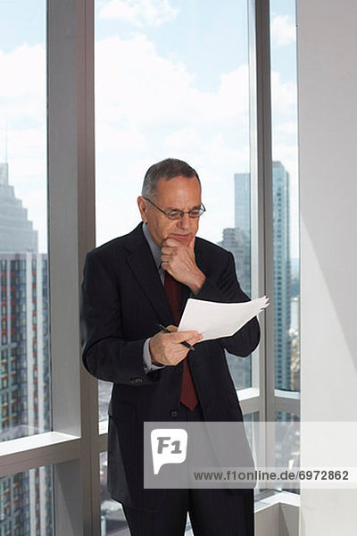 Businessman Looking at Document