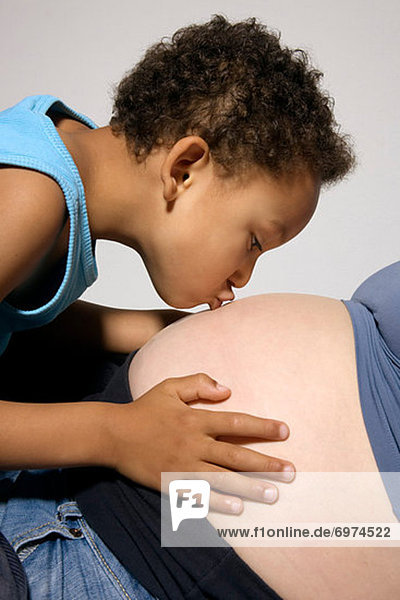 Boy Kissing Pregnant Mothers Stomach