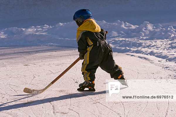 Little Boy Playing Hockey on a Frozen Pond  Fuschlsee  Salzburger Land  Austria
