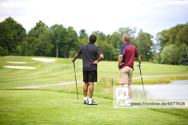 Backview of Men Standing on Golf Course