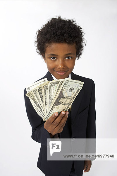 Little Boy Dressed Up as a Businessman Holding Cash