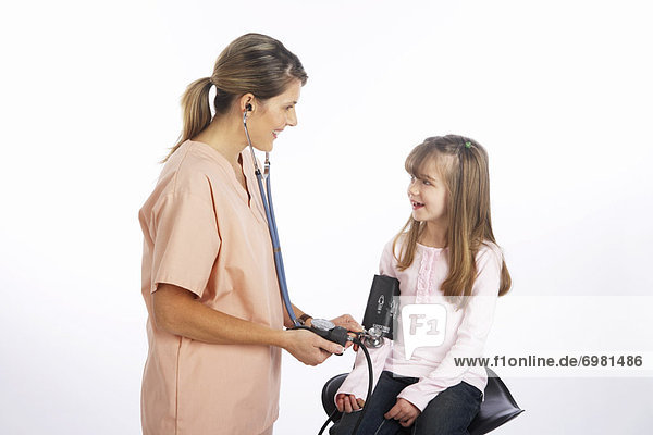 Nurse Checking Girls Blood Pressure