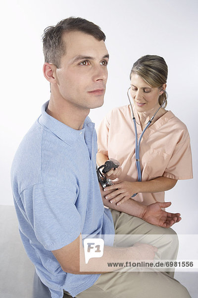Nurse Testing Mans Blood Pressure