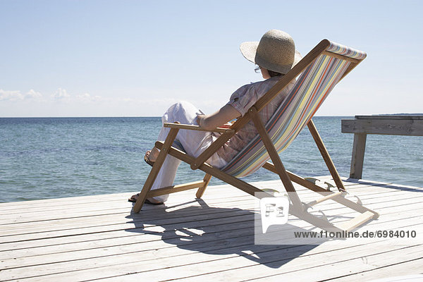 Woman Sitting on Deck Chair