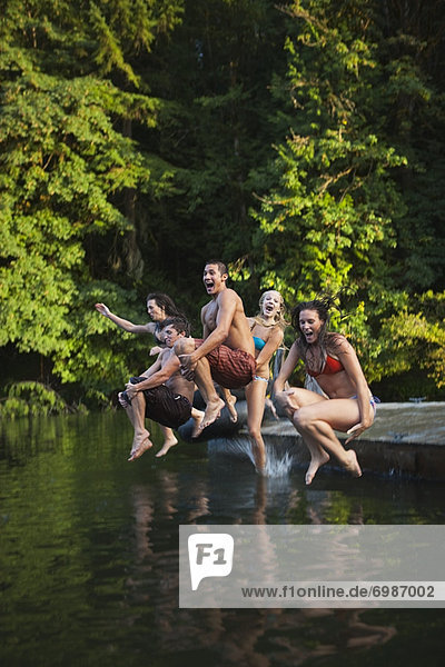 Group of Friends Jumping Into Lake  Near Portland  Oregon  USA