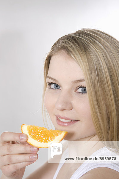 Woman Eating Slice of Orange
