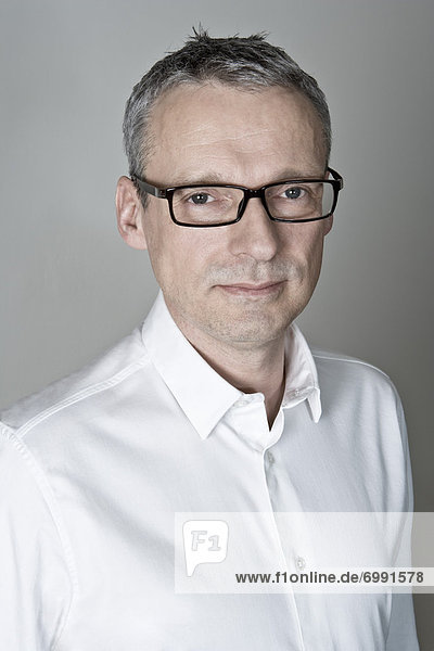 Portrait of Man wearing White Shirt and Eyeglasses