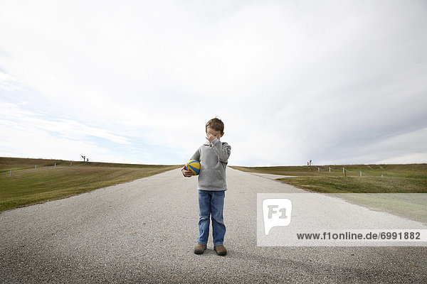 Boy Standing on Road