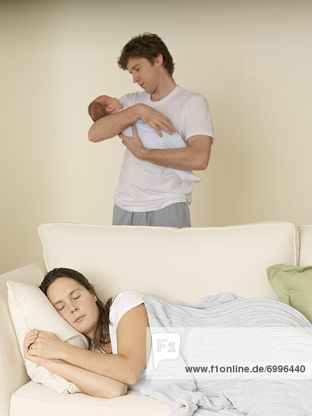Mother Sleeping and Father with Baby