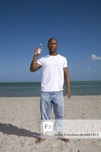 Man on the Beach Holding a Cell Phone  Florida  USA