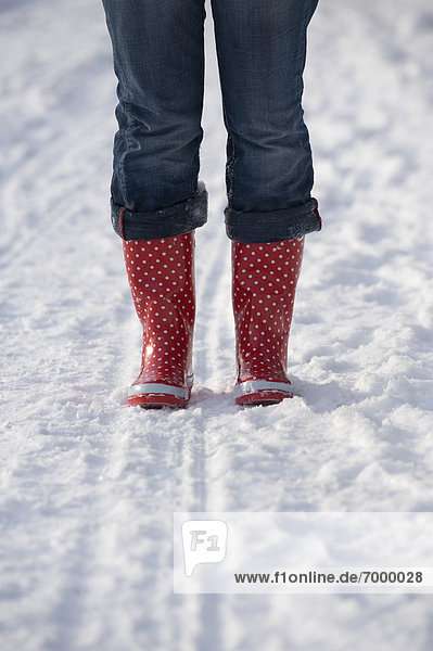 Woman wearing Rubber Boots in Snow  Salzburg  Austria