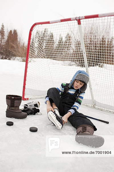Boy Putting On Hockey Skates  Frisco  Summit County  Colorado  USA