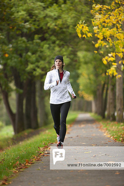 Woman Jogging through Park  Seattle  Washington  USA