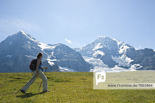 Woman Hiking using Walking Sticks  Bernese Oberland  Switzerland
