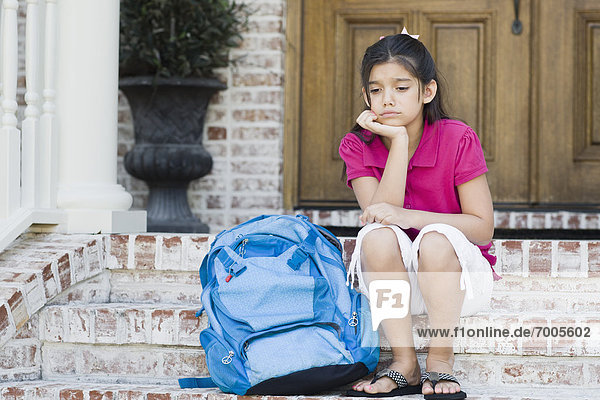 Girl with Backpack Sitting on Steps