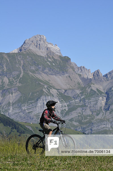 Boy Riding Bicycle in Mountains  Alps  France