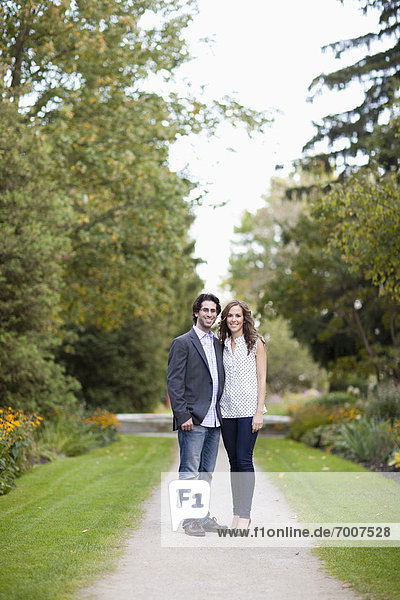 Portrait of Young Couple Standing on Walkway in Park  Ontario  Canada