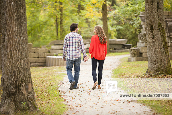 Backview of Young Couple Walking through Park in Autumn  Ontario  Canada