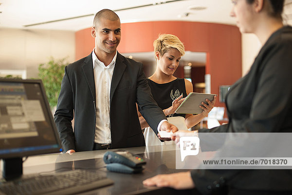 Businessman checking into hotel