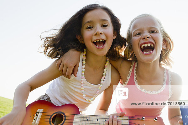 Girls singing together outdoors