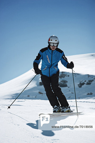 Skier coasting on snowy slope