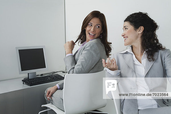 Women chatting together in office