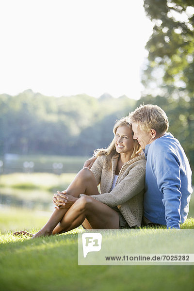 Couple sitting on lawn