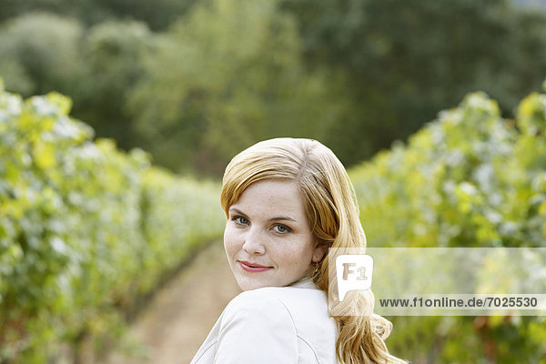 Young woman in vineyard (portrait)