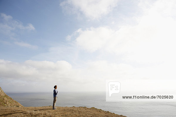 Man standing on cliff by ocean  Point Reyes National Park  California  USA