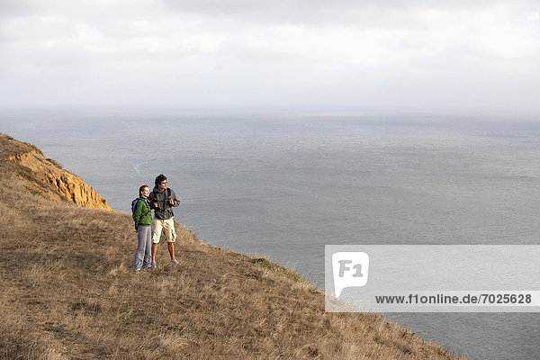 Hikers looking at view on cliff