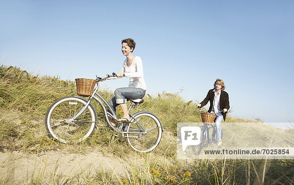 Couple cycling in field