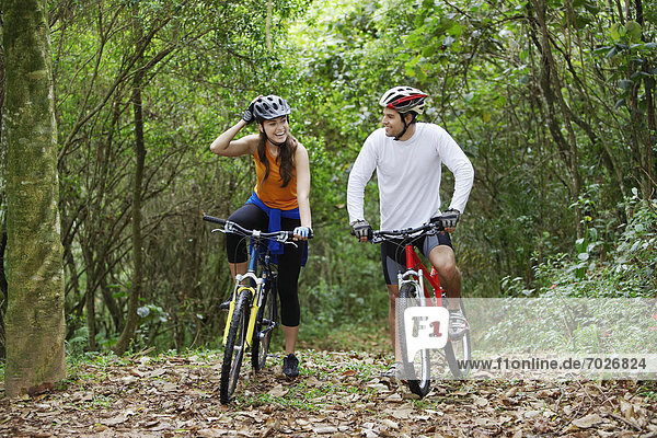 Couple cycling in forest