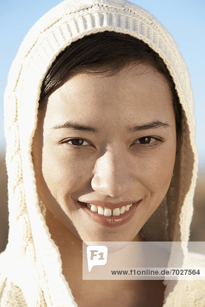 Young woman wearing hood (portrait)