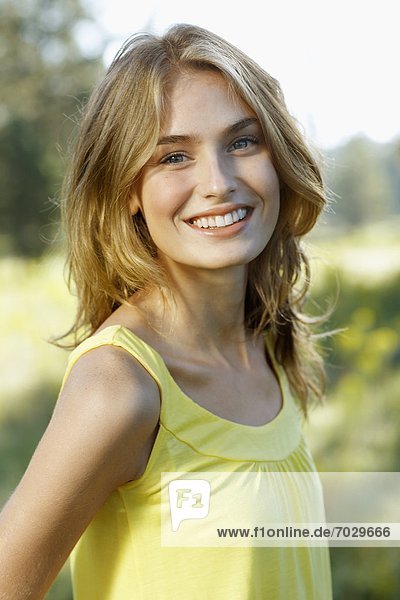 Portrait of young woman in yellow tank top