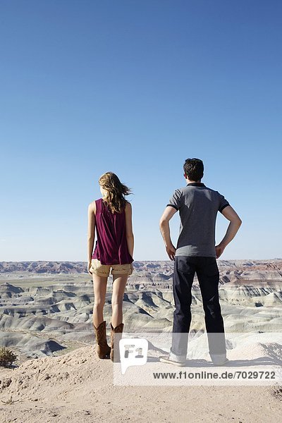 Young couple looking at rocky landscape  Arizona  USA