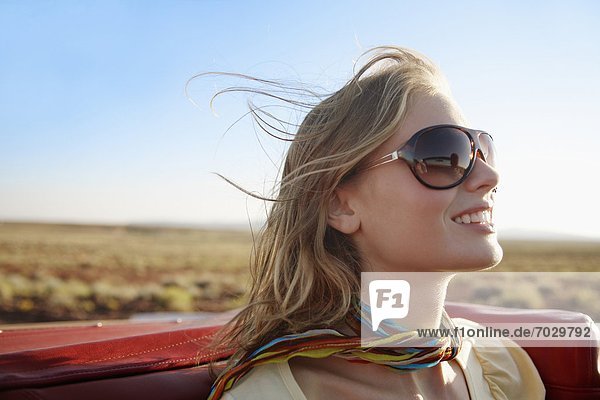 Young woman in convertible
