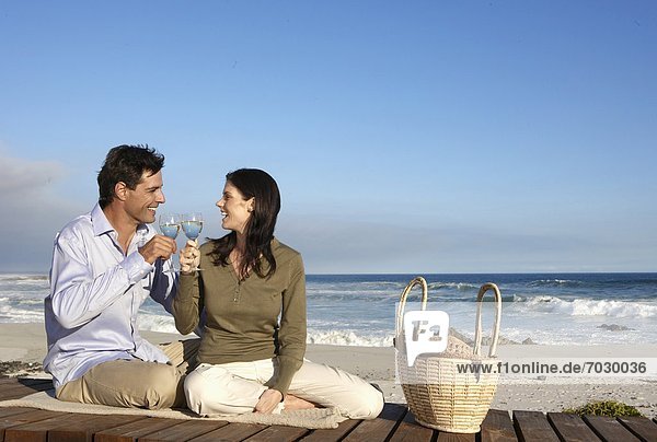 Couple drinking wine on beach  Cape Town  South Africa