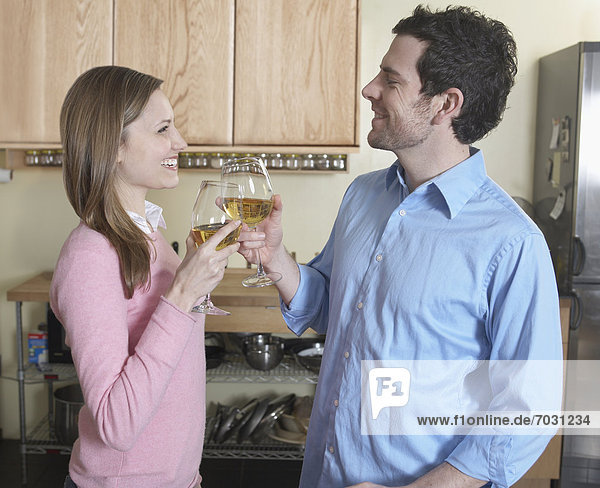 Mid-Adult Couple Toasting with White Wine