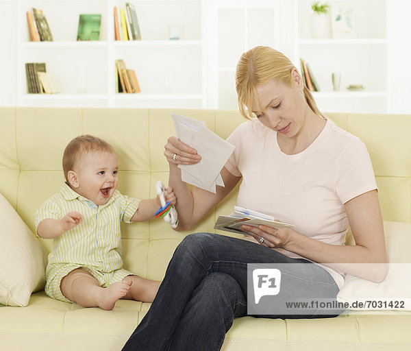Mother with Baby Boy Checking Mail
