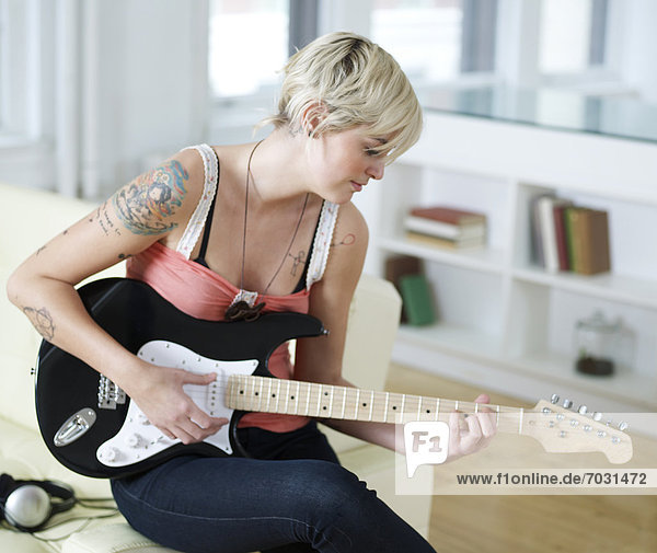 Young Woman Playing Electric Guitar