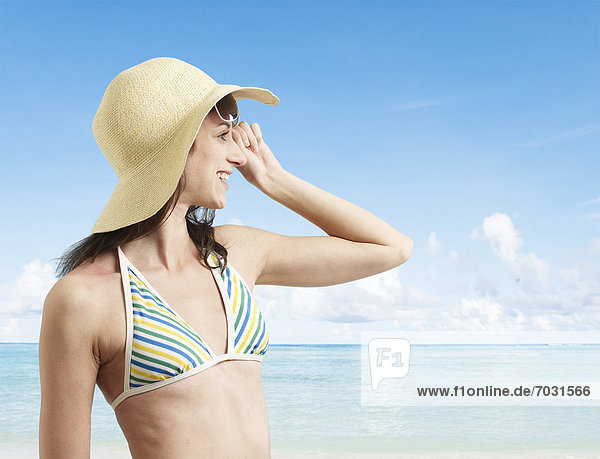 Young Woman Wearing Sunhat on Beach