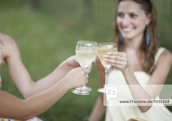Three Women Toasting with White Wine