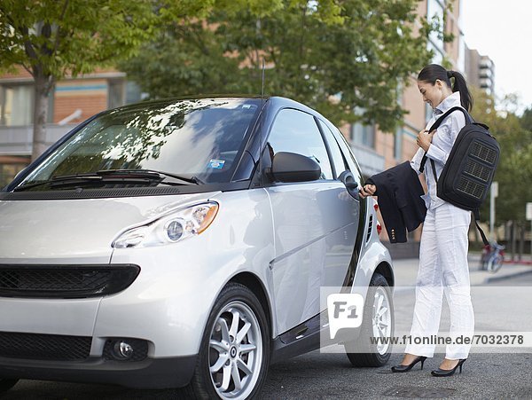 Mid-Adult Woman Getting Into Smart Car