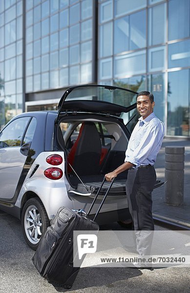 Businessman Unloading Smart Car