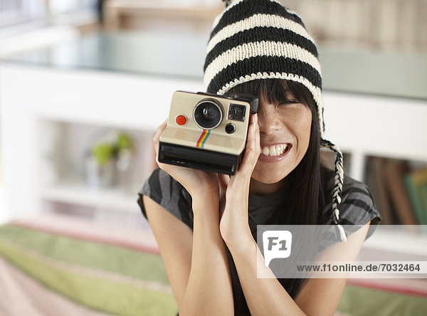 Mid Adult Woman Using Instant Camera