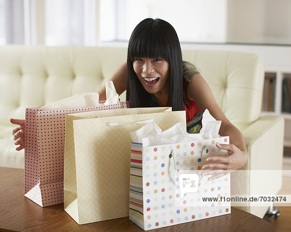 Mid Adult Woman Grabbing Shopping Bags