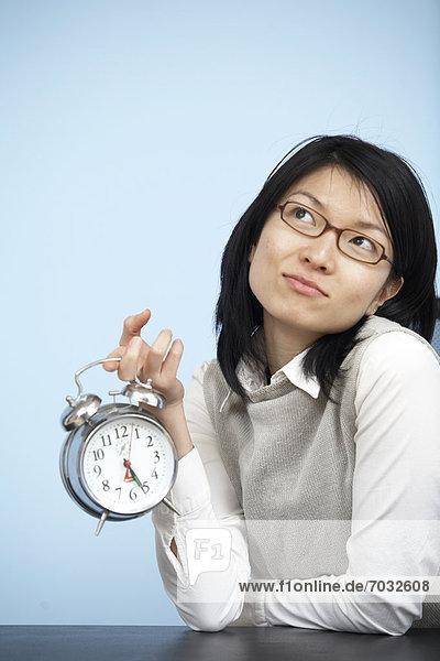 Mid-Adult Businesswoman Holding Alarm Clock