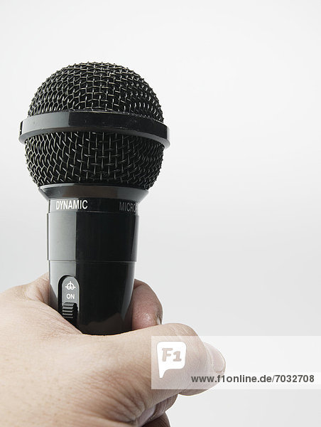 Person Holding Microphone